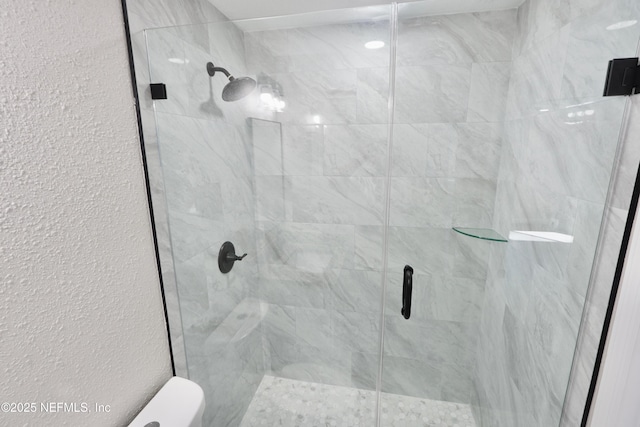 full bath with a stall shower and a textured wall