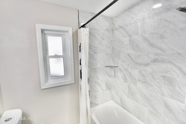 bathroom with shower / tub combo with curtain and toilet