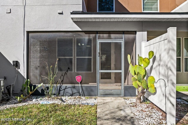 view of exterior entry with stucco siding