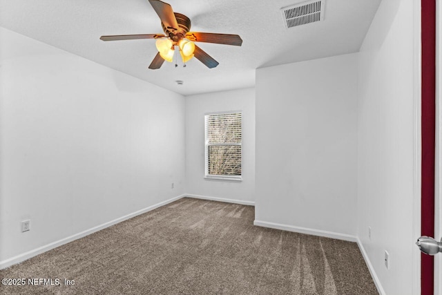 empty room featuring a textured ceiling, a ceiling fan, visible vents, baseboards, and carpet