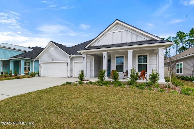 view of front of property featuring a garage, covered porch, board and batten siding, and a front yard