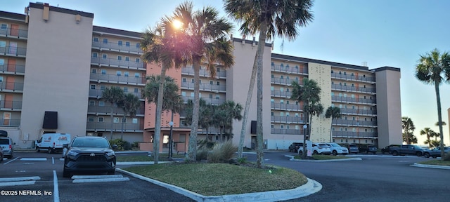 view of property featuring uncovered parking