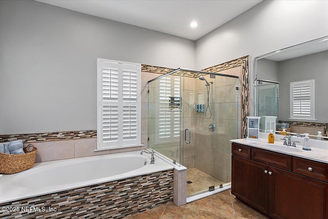 full bathroom featuring a garden tub, tile patterned floors, vanity, and a stall shower