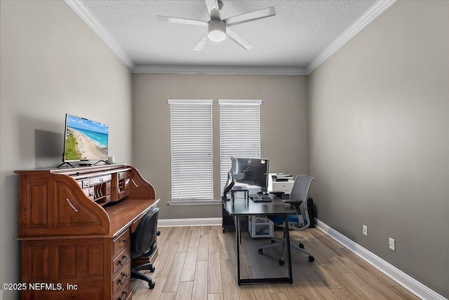 home office featuring baseboards, ceiling fan, a textured ceiling, crown molding, and light wood-style floors