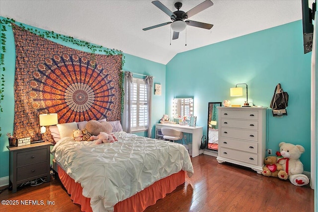 bedroom featuring vaulted ceiling, ceiling fan, dark wood-style flooring, and baseboards