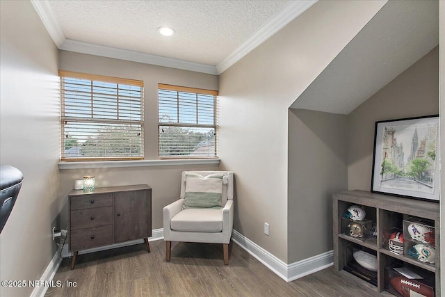 living area with crown molding, a textured ceiling, baseboards, and wood finished floors