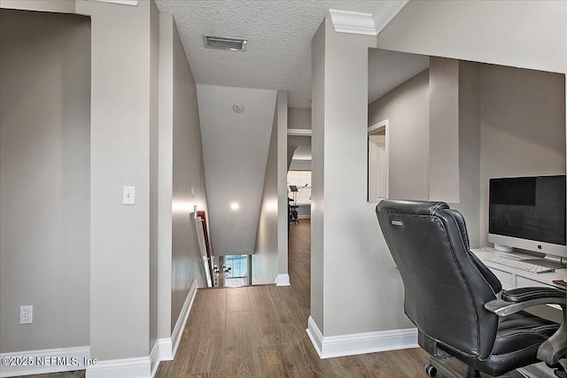 office featuring visible vents, dark wood finished floors, a textured ceiling, and baseboards