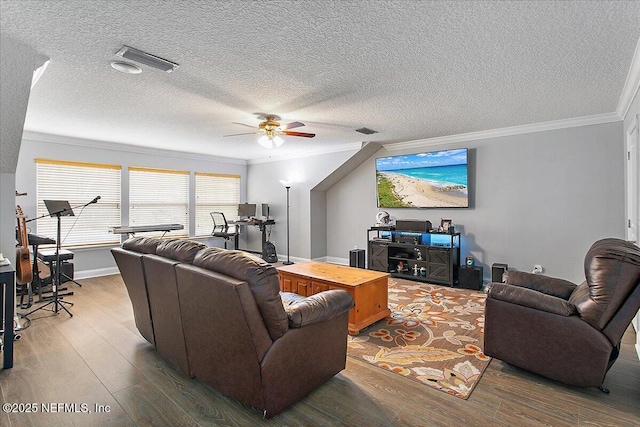 living area with ceiling fan, visible vents, crown molding, and wood finished floors