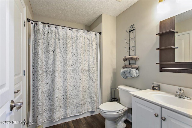 bathroom featuring a textured ceiling, wood finished floors, and vanity