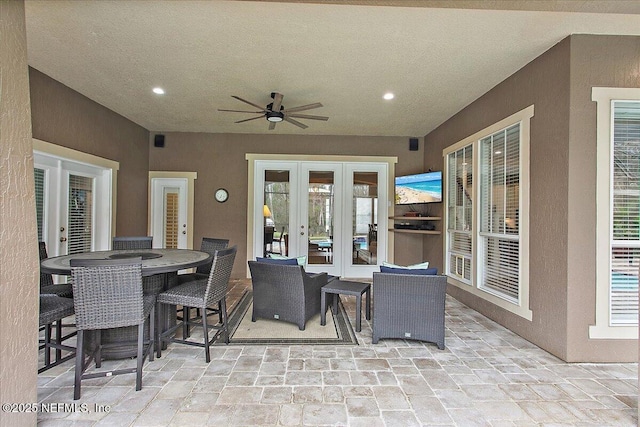 view of patio / terrace featuring outdoor dining space, a ceiling fan, and french doors