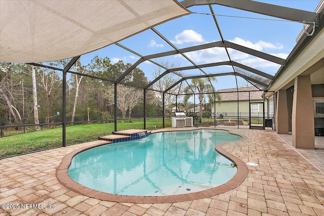 pool with a lanai, a patio area, and a yard