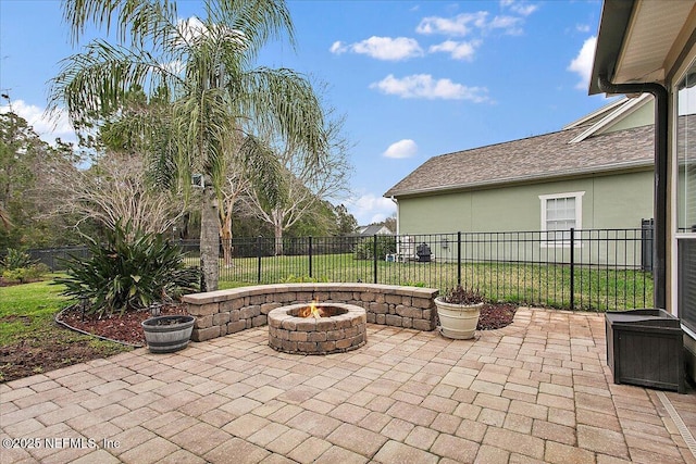 view of patio featuring an outdoor fire pit and a fenced backyard