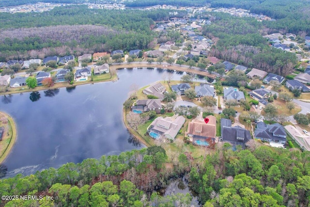 aerial view featuring a residential view, a water view, and a wooded view