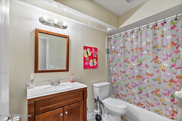 bathroom featuring toilet, a textured wall, shower / tub combo with curtain, and vanity