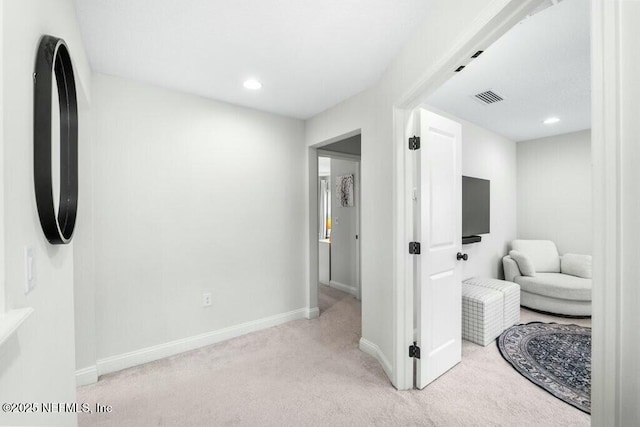 interior space featuring recessed lighting, light colored carpet, visible vents, and baseboards