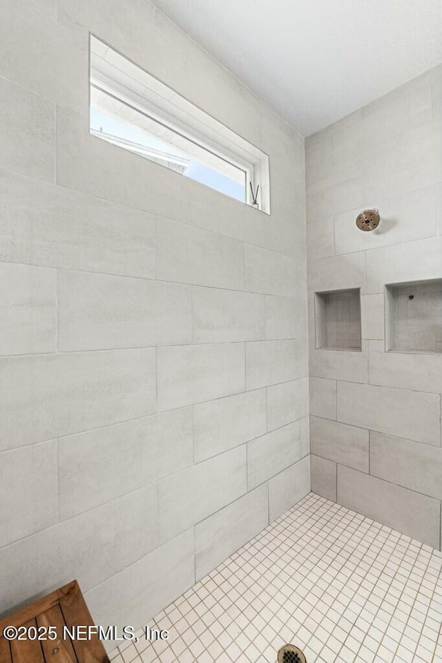 full bath featuring a tile shower