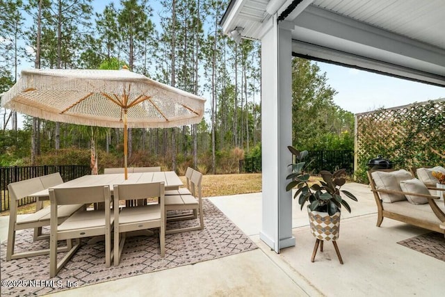 view of patio / terrace featuring outdoor dining area and fence