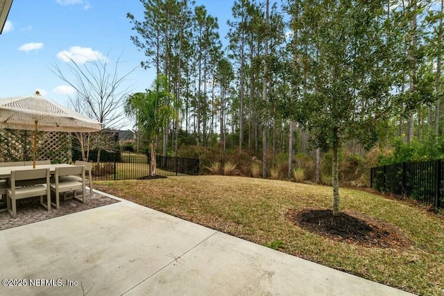 view of yard with fence and a patio