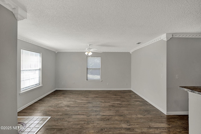 spare room featuring a textured ceiling, crown molding, dark hardwood / wood-style floors, and ceiling fan