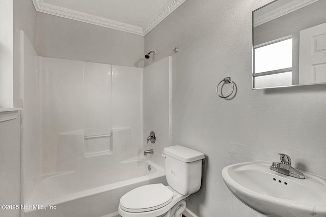 full bathroom featuring shower / bathing tub combination, toilet, a textured ceiling, ornamental molding, and sink