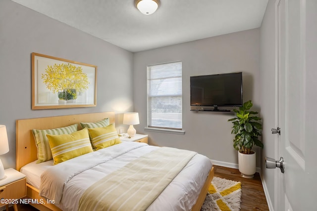 bedroom with dark hardwood / wood-style flooring