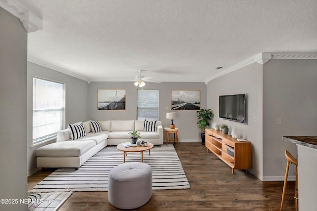 living room featuring dark hardwood / wood-style flooring, ornamental molding, a wealth of natural light, and ceiling fan