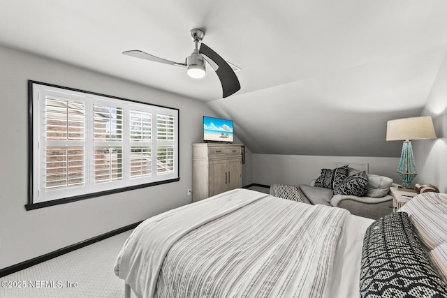 carpeted bedroom featuring lofted ceiling, ceiling fan, and baseboards