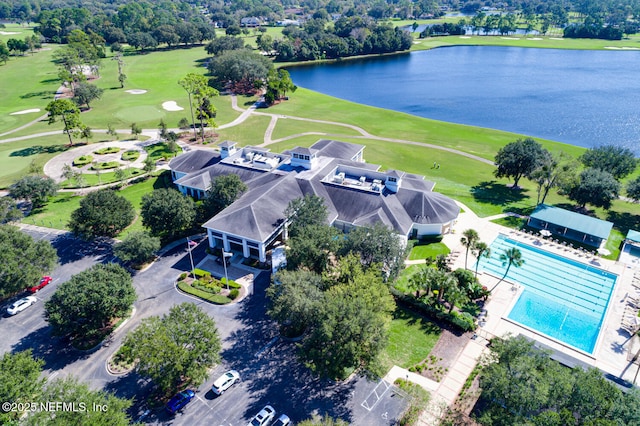 drone / aerial view featuring view of golf course and a water view