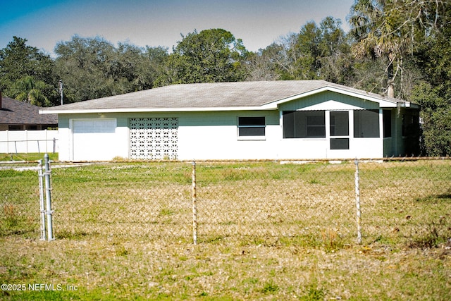 view of home's exterior featuring fence and a lawn