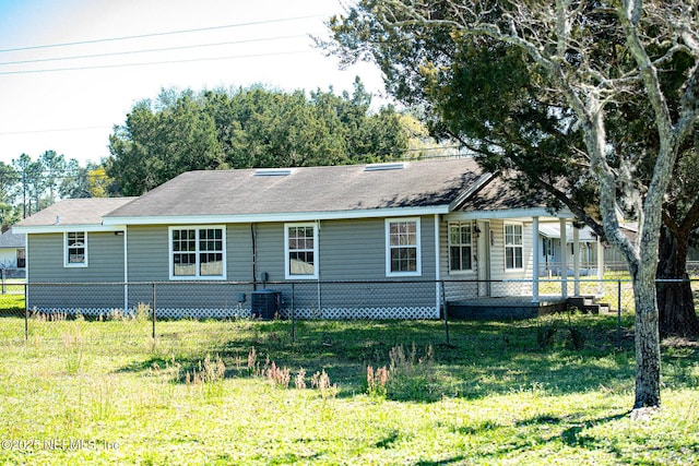 view of front facade with a front lawn, cooling unit, and fence private yard