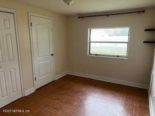 unfurnished bedroom with baseboards