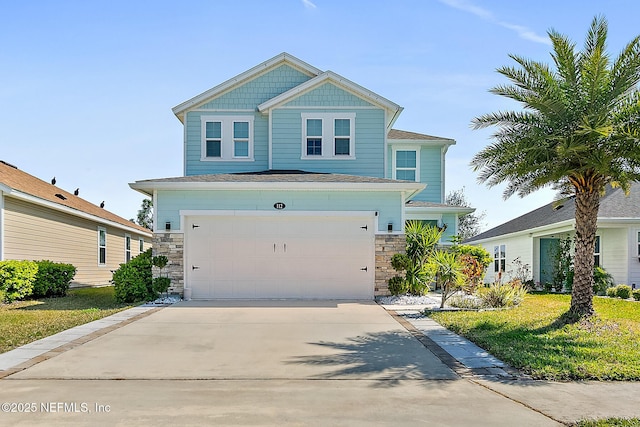 view of front of house featuring stone siding, an attached garage, and driveway