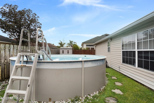 view of swimming pool featuring a shed