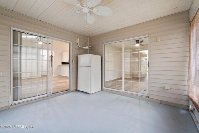 unfurnished sunroom featuring ceiling fan