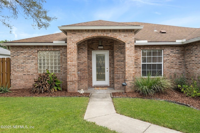 doorway to property with a lawn