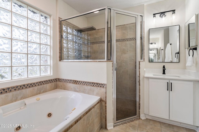 bathroom featuring vanity, plus walk in shower, and tile patterned flooring