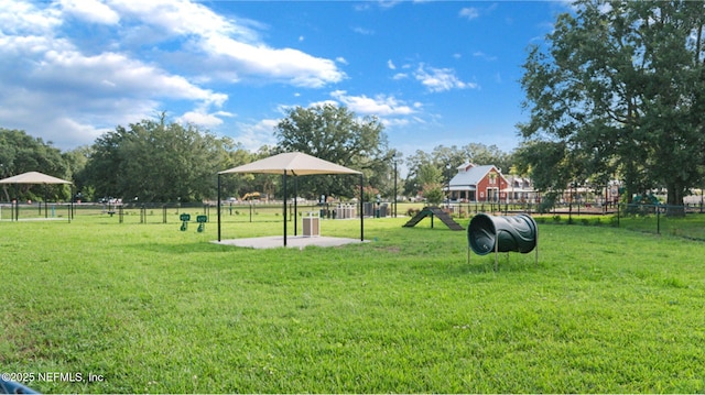 view of property's community with a yard and fence