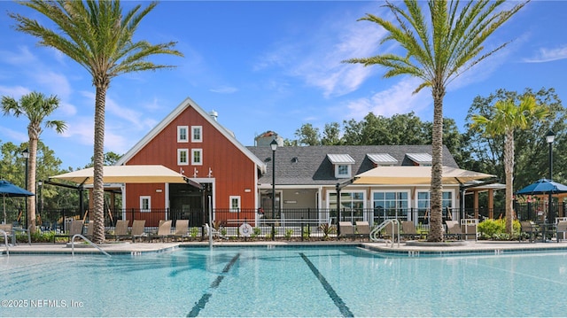 view of swimming pool featuring a patio and fence