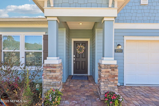 entrance to property featuring an attached garage