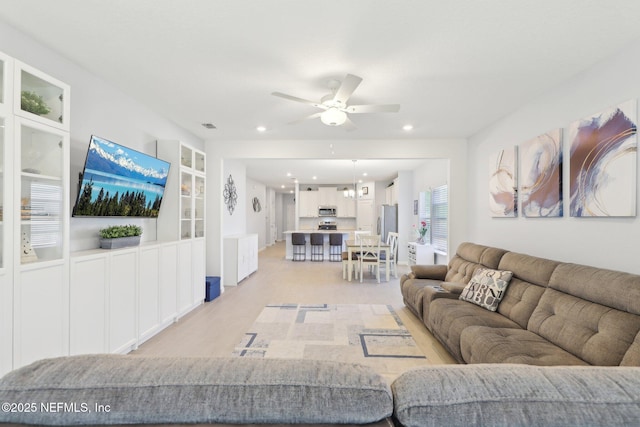 living area featuring recessed lighting, a ceiling fan, and visible vents