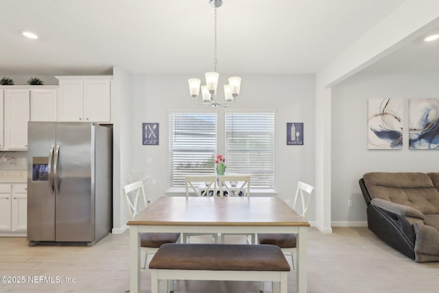 dining space with recessed lighting, baseboards, and a chandelier