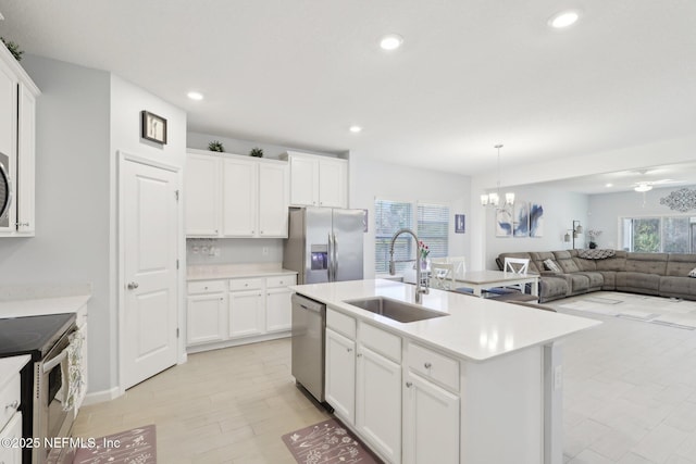 kitchen featuring appliances with stainless steel finishes, light countertops, and a sink