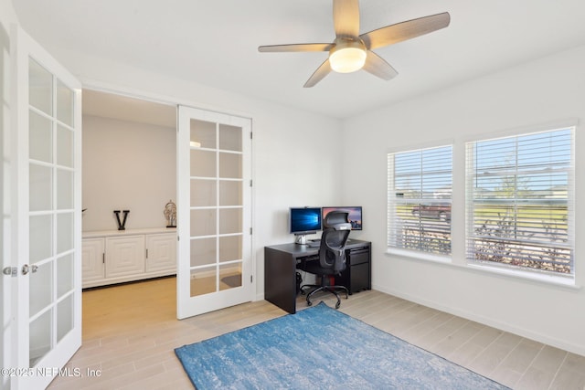 office space with french doors, baseboards, light wood-type flooring, and a ceiling fan