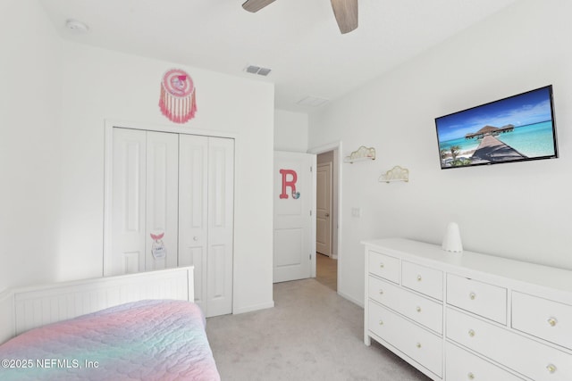 bedroom featuring a ceiling fan, baseboards, visible vents, a closet, and light carpet