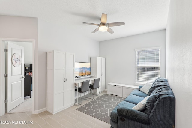 office space with built in desk, baseboards, and ceiling fan