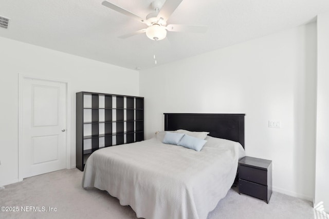 carpeted bedroom featuring visible vents and a ceiling fan