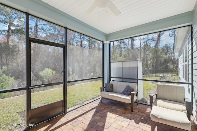 sunroom with a ceiling fan