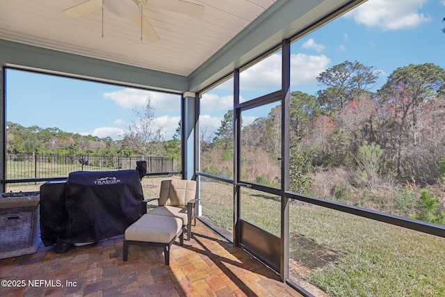 sunroom featuring a wealth of natural light and a ceiling fan