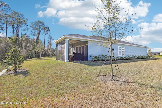 view of side of property with a lawn and a sunroom