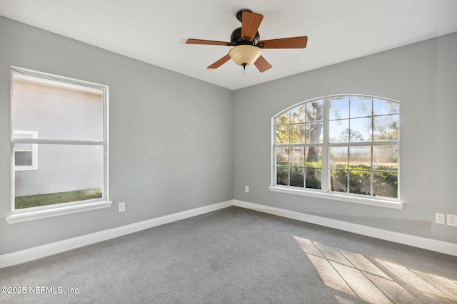 carpeted empty room featuring ceiling fan